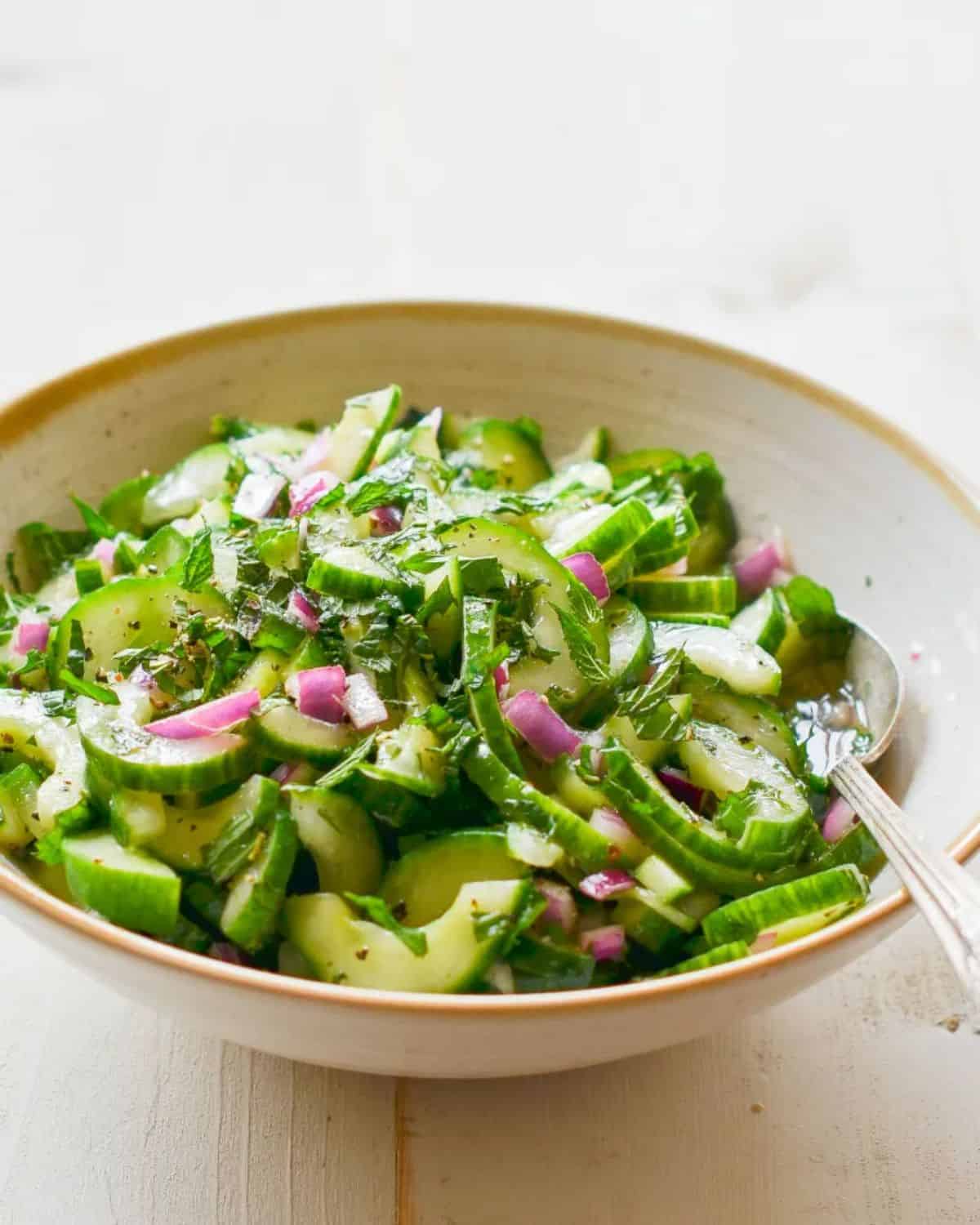 Cucumber Salad with Mint in a bowl with a spoon.