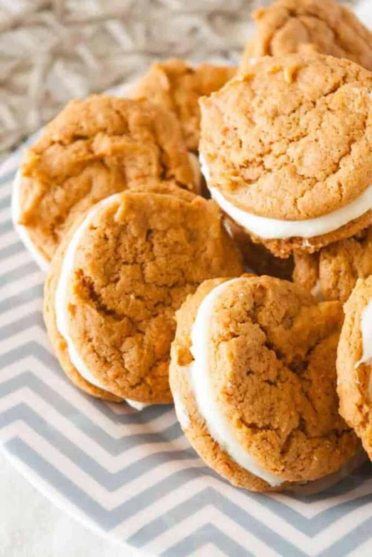 Carrot Cake Oreos on a blue-white plate.