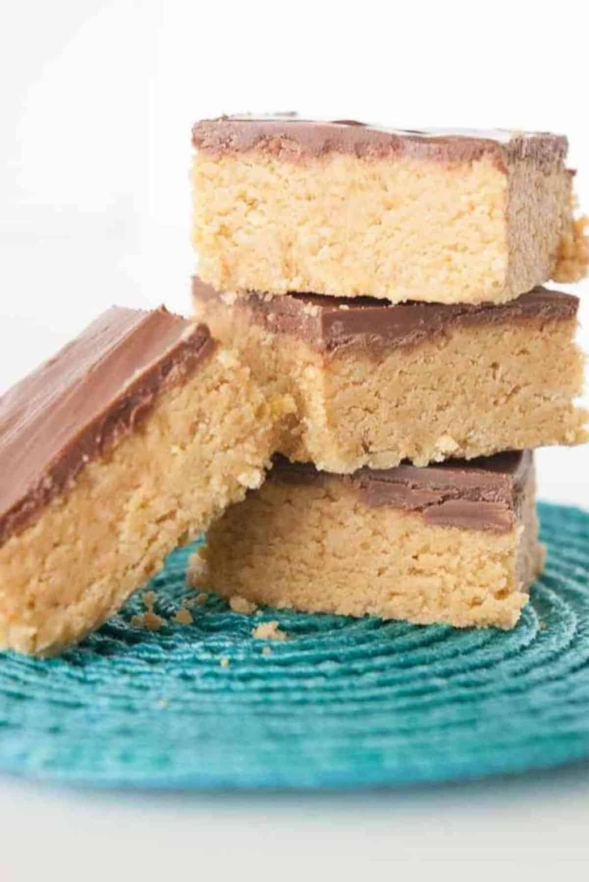A pile of 5 Ingredient No-Bake Peanut Butter Bars on a blue tray.