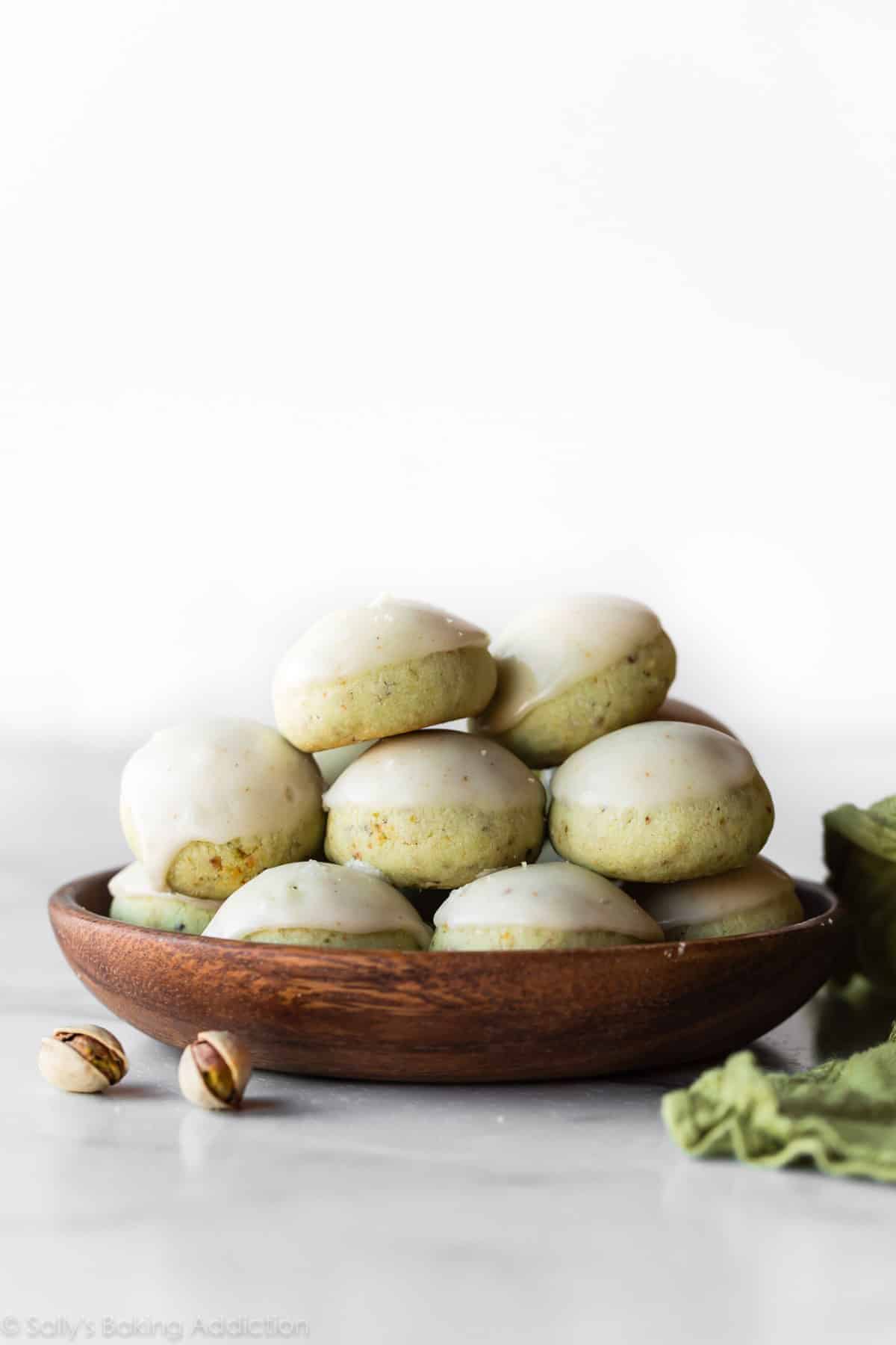 Pistachio Drop Cookies on a wooden plate.