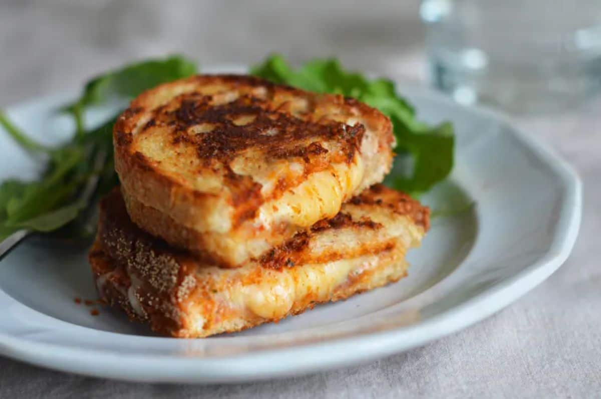 Grilled Cheese Sandwiches with Sun-dried Tomatoes on a blue plate.