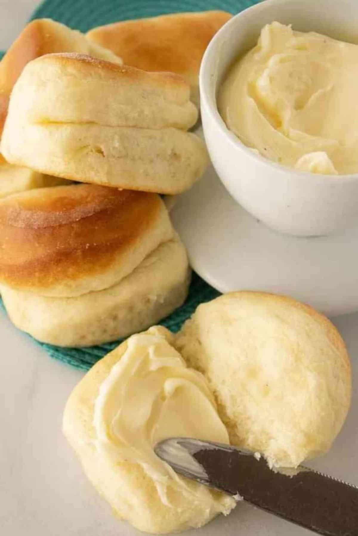 Parker House Rolls spread with butter.