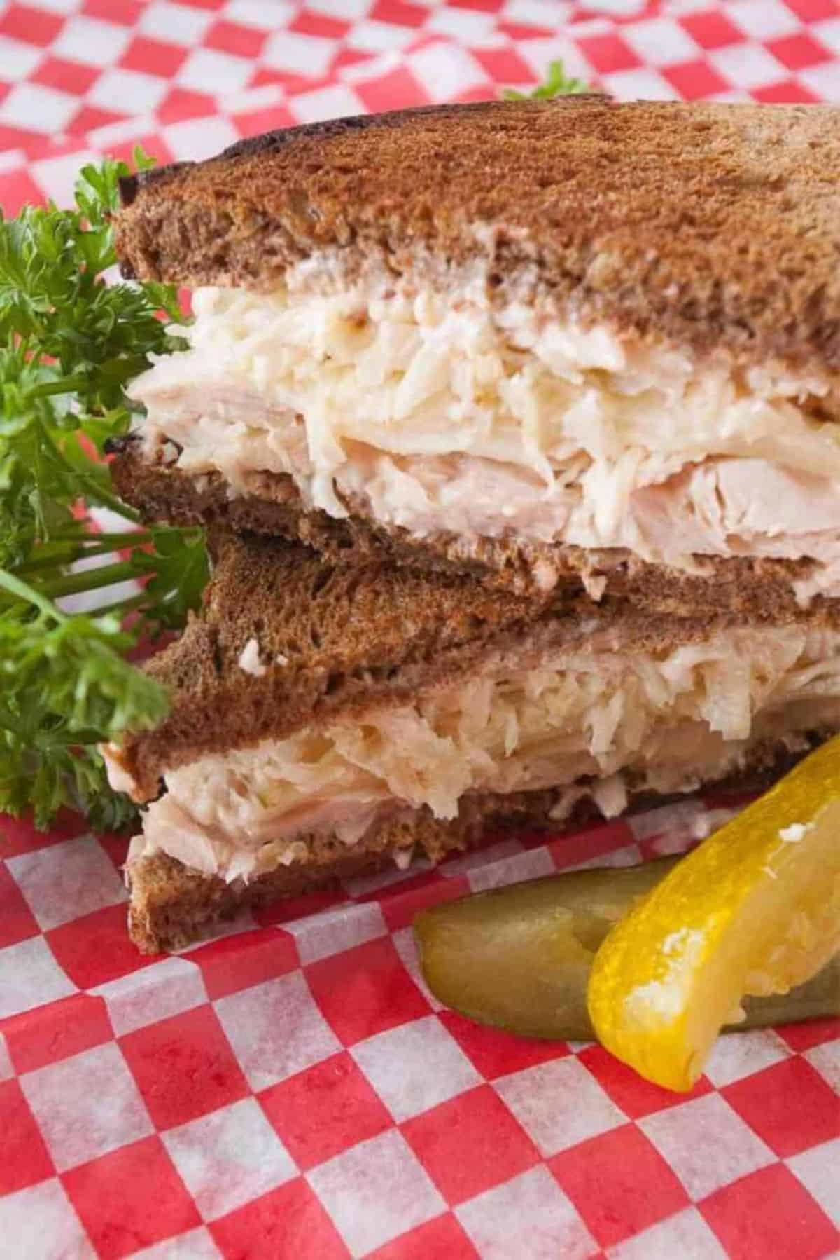 Two Easy Turkey Reuben Sandwiches on a table.