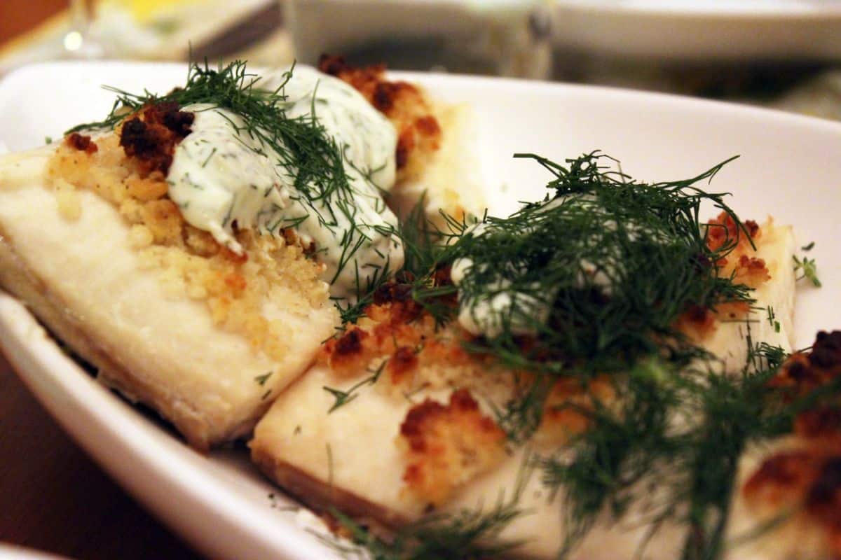 Dill and Parmesan Crusted Halibut on a white tray.