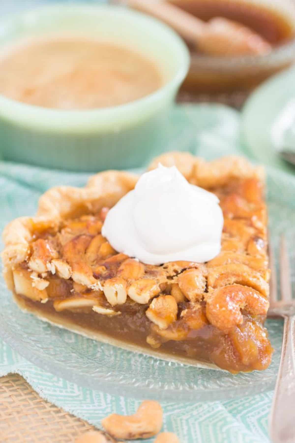 A piece of Salted Caramel Cashew Pie on a glass plate.