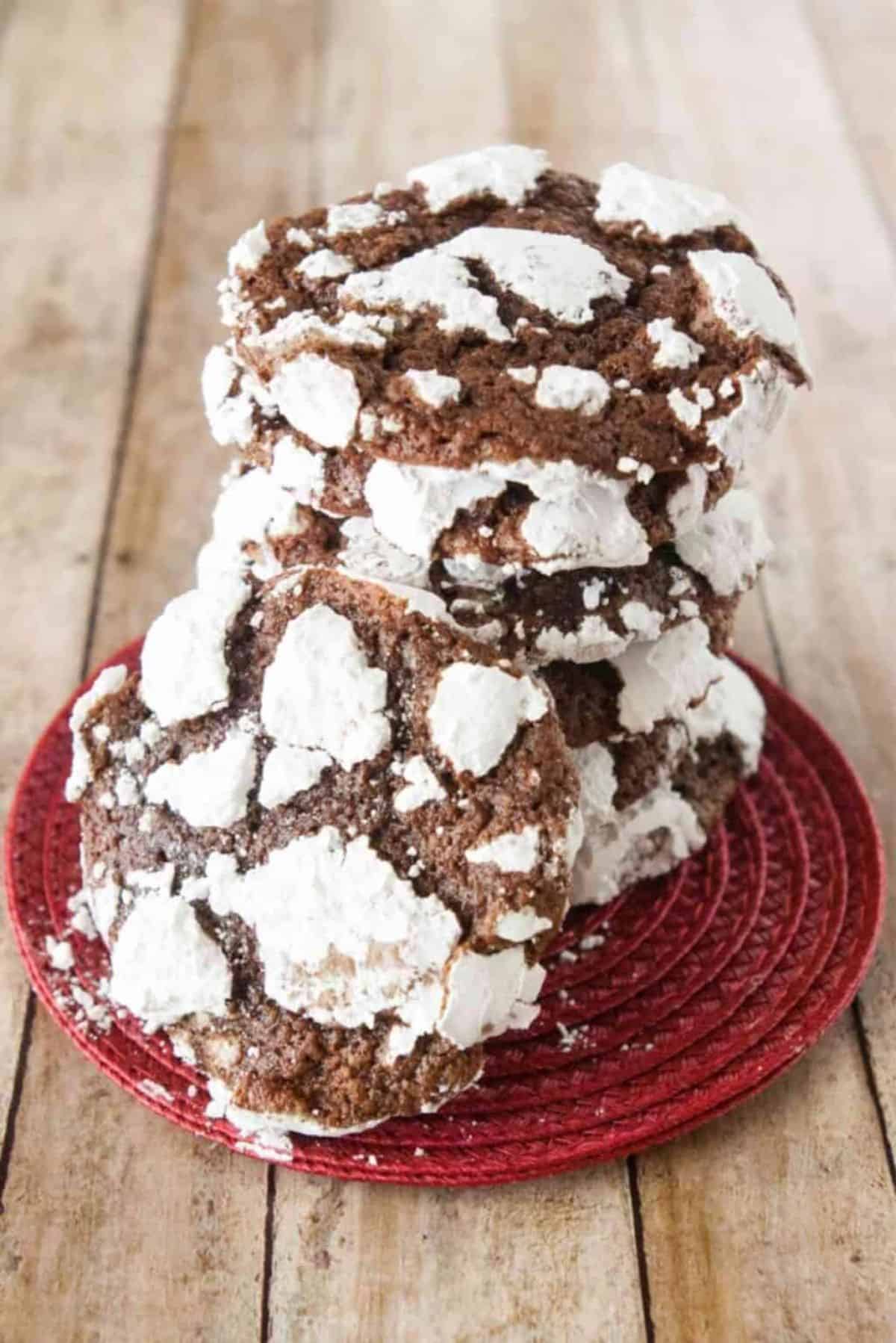 A pile ofChocolate Crackle Cookies on a red plate.