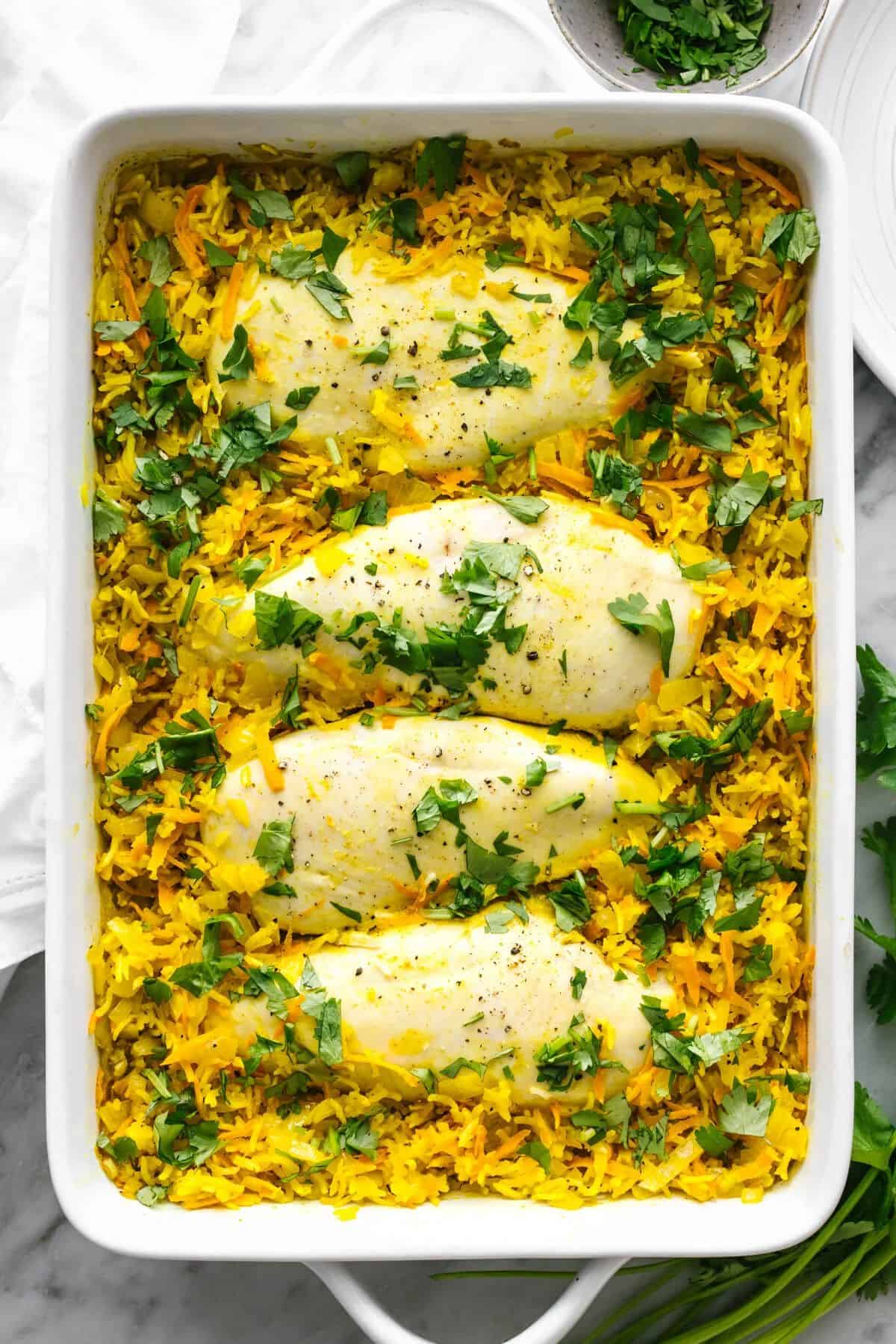 Chicken and Turmeric Rice in a white casserole.