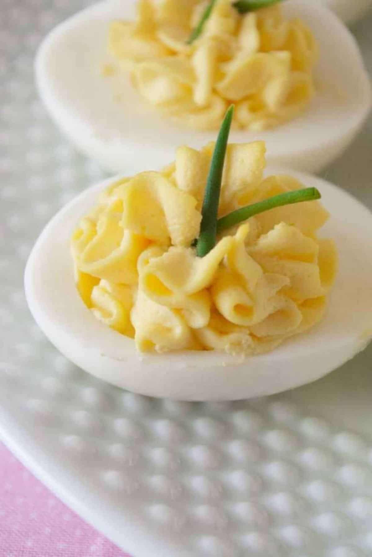 Delicious Secret Ingredient Deviled Eggs on a white plate.