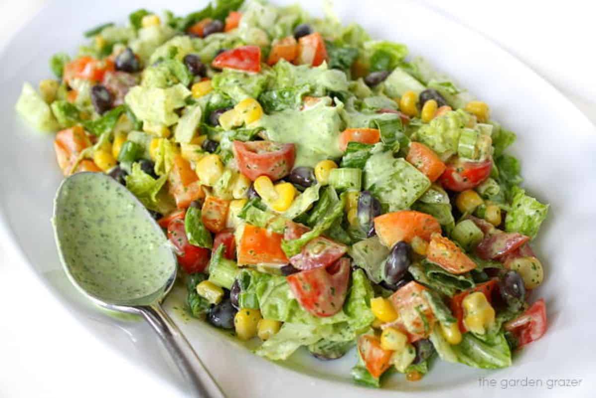 Southwestern Chopped Salad with Cilantro Lime Dressing on a white plate with a spoon.