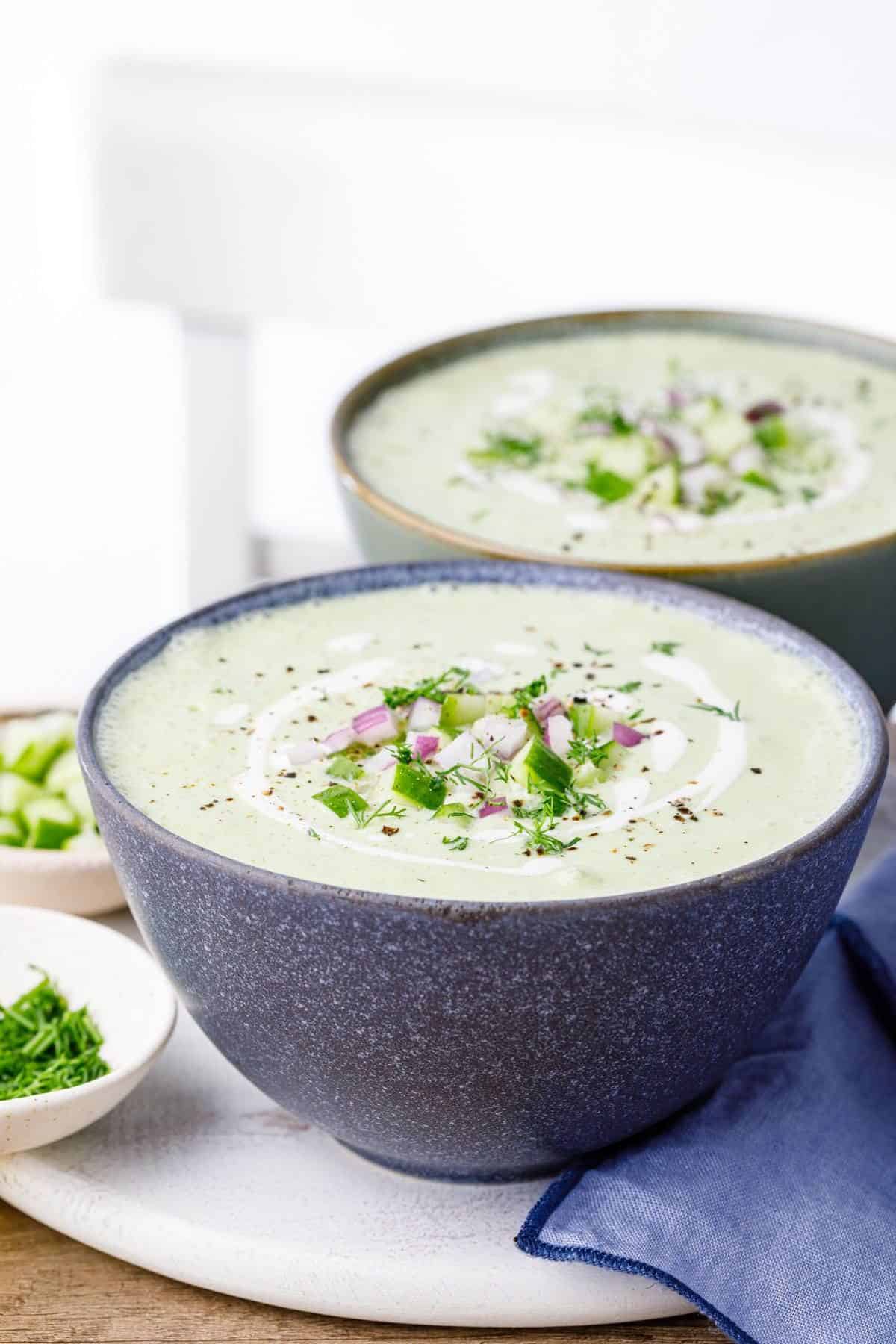 Creamy Dill and Cucumber Soup in two gray bowls.