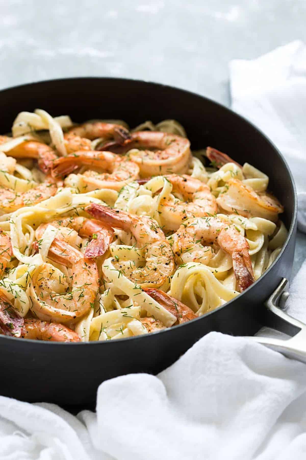 Dill and Lemon Shrimp Pasta in a black skillet.