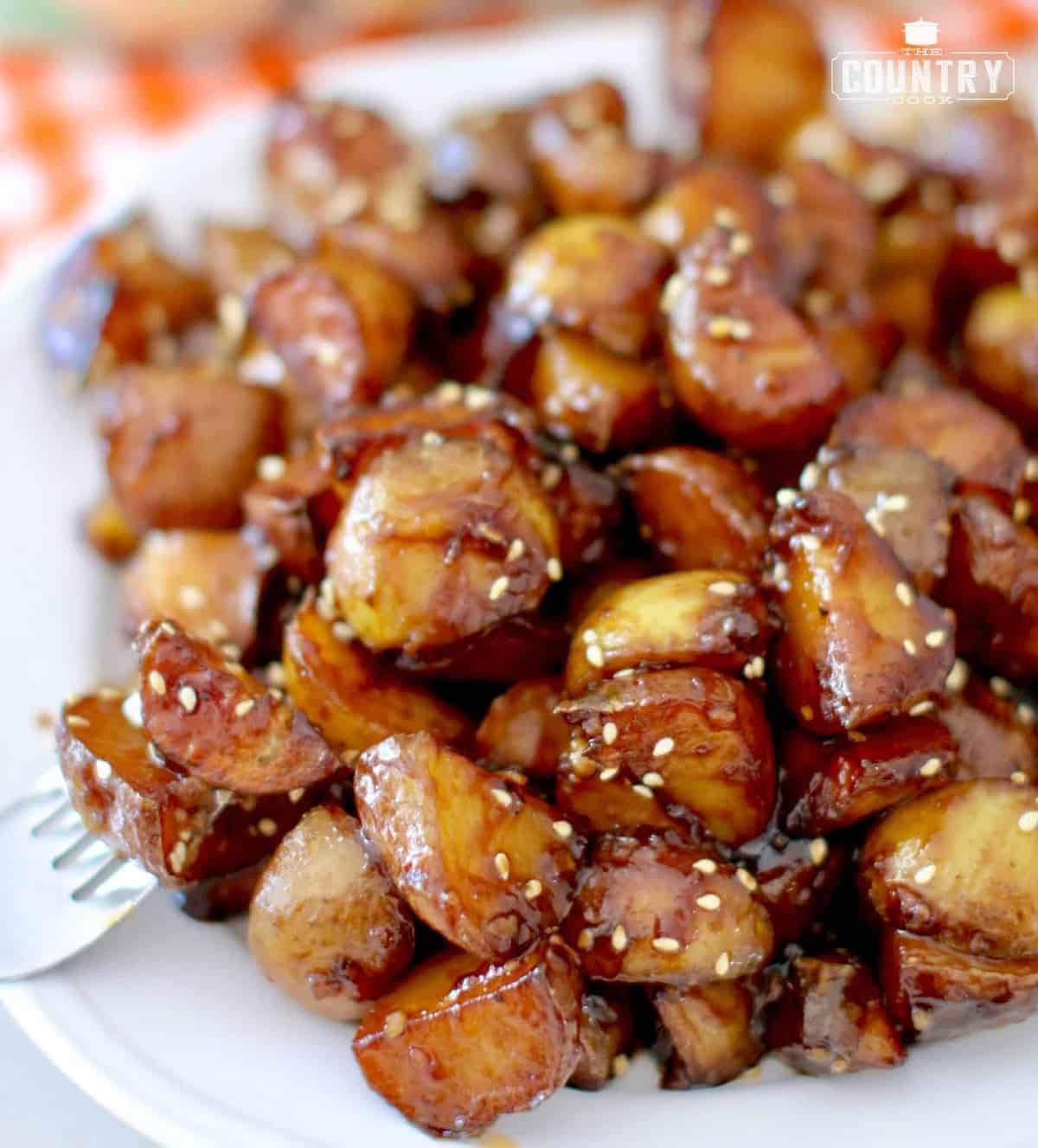 Delicious Korean-Style Sticky Potatoes on a white plate.