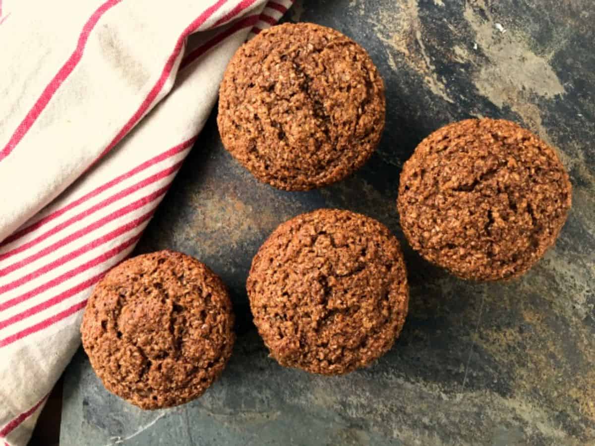 Four Bran Muffins on a table.