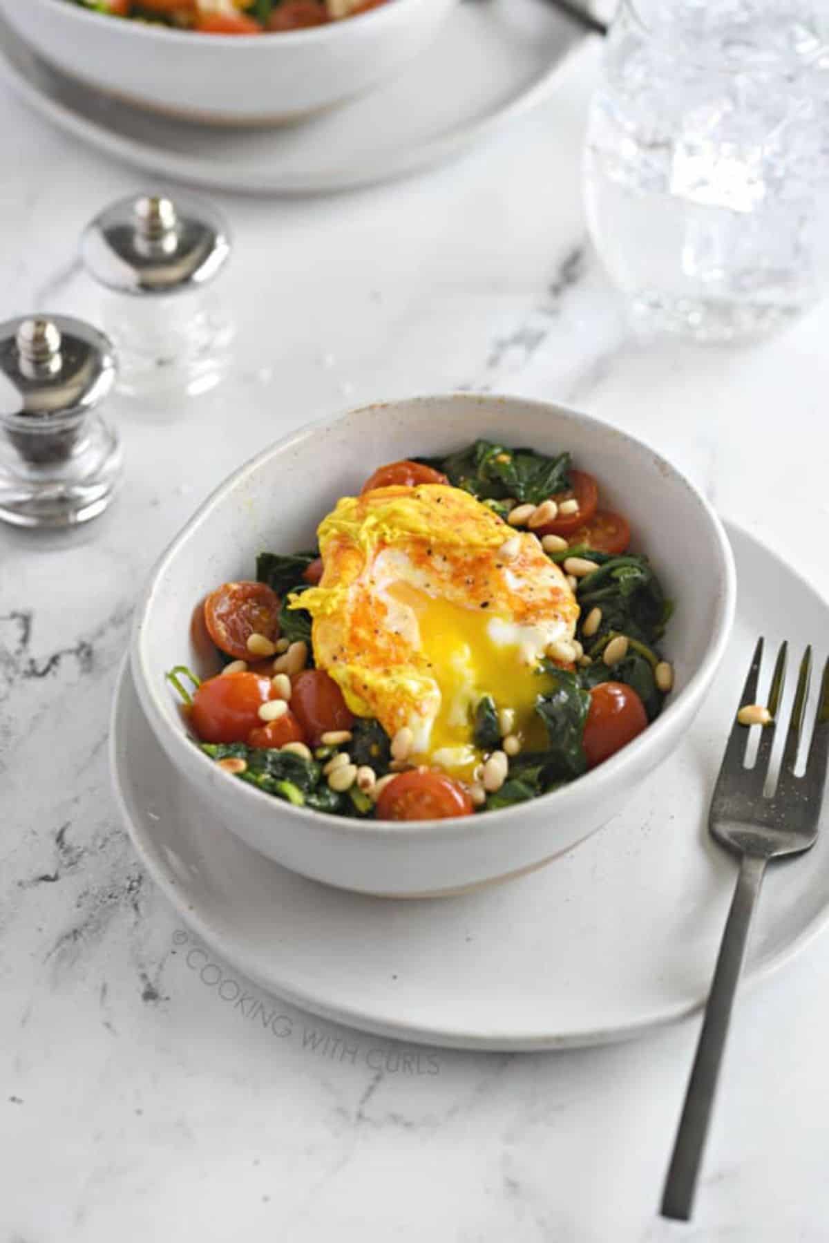 Poached Eggs With Turmeric in a white bowl.