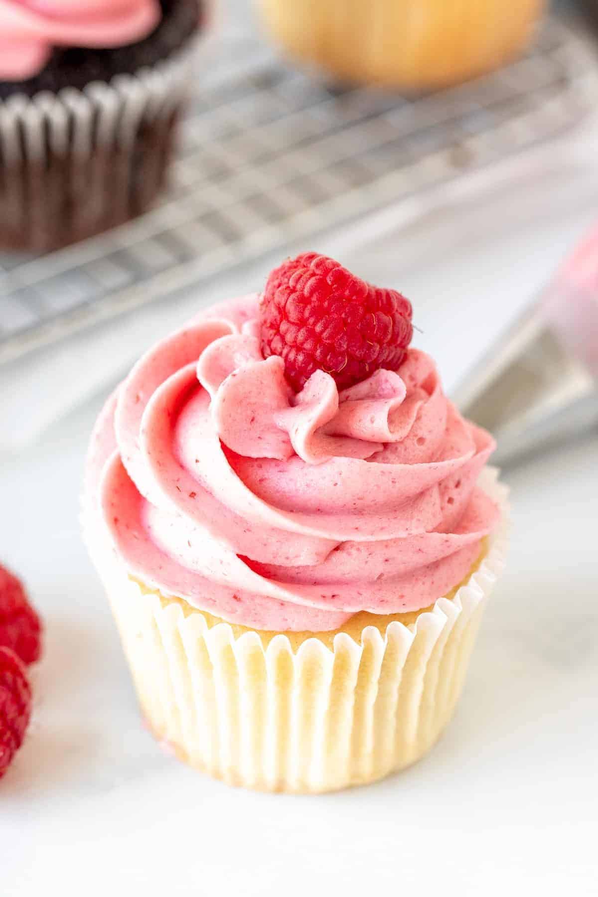 Raspberry Buttercream Frosting on a cupcake.