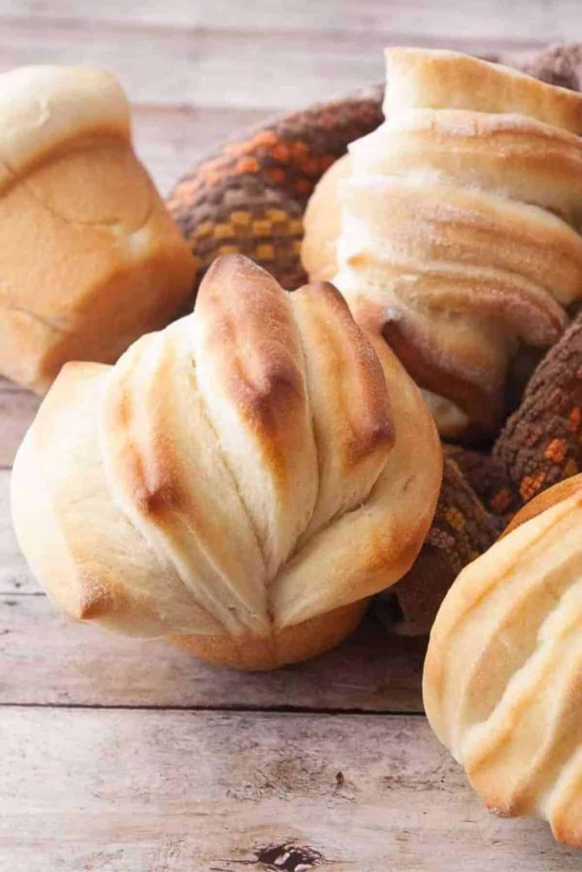 Crunchy Butterflake Rolls on a wooden table.