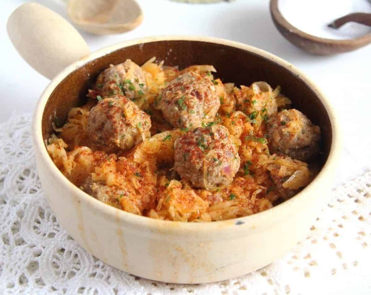 Deliicous German Meatballs With Sauerkraut in a bowl.