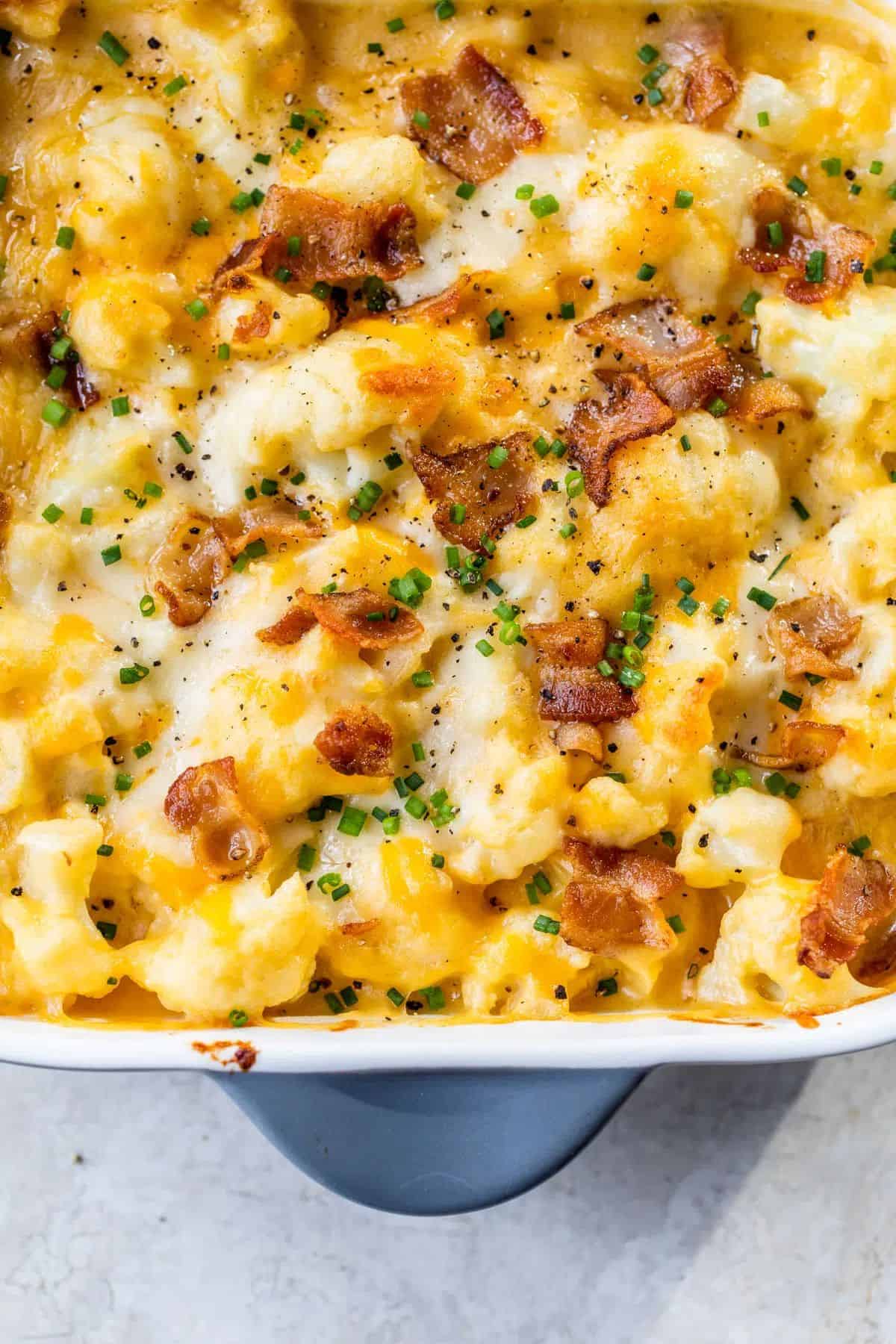 Delicious Cheesy Cauliflower Bake in a white casserole.