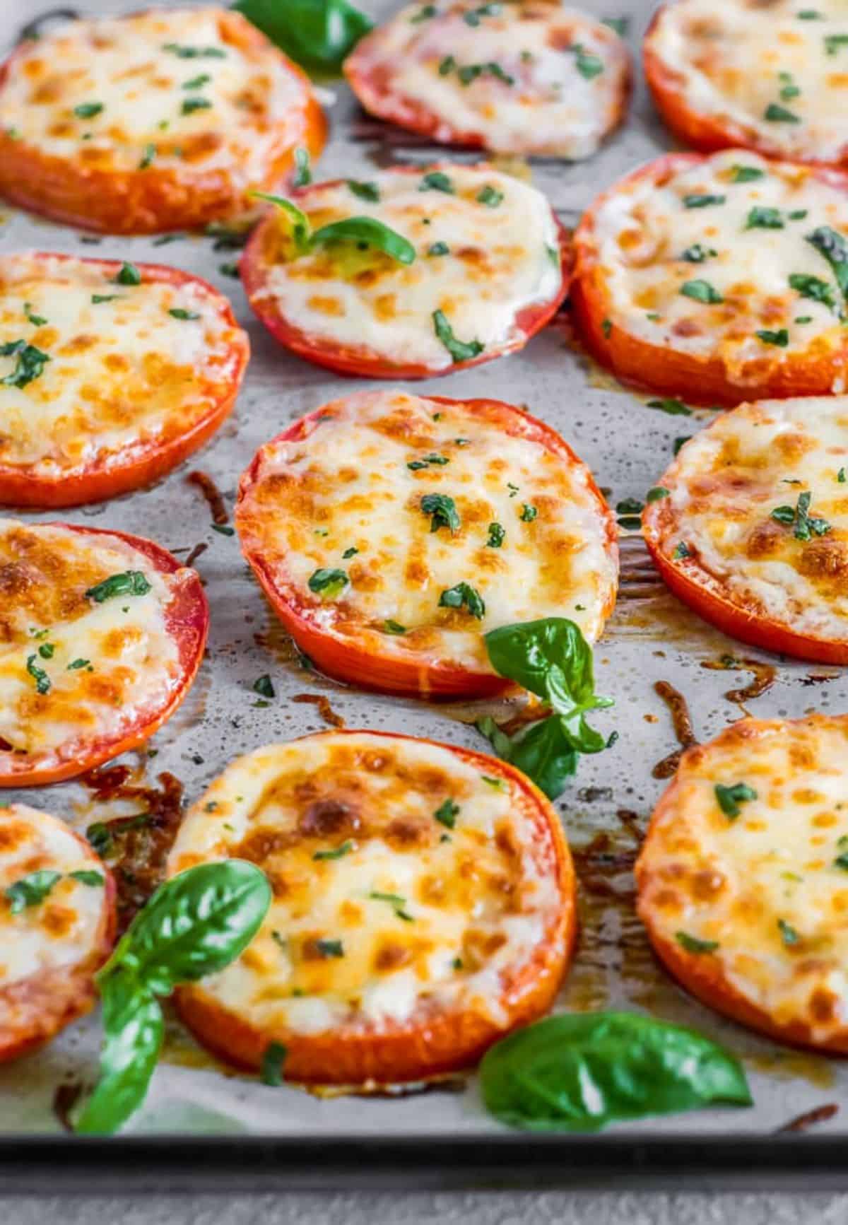 Delicious Baked Tomatoes with Mozzarella & Parmesan on a tray.