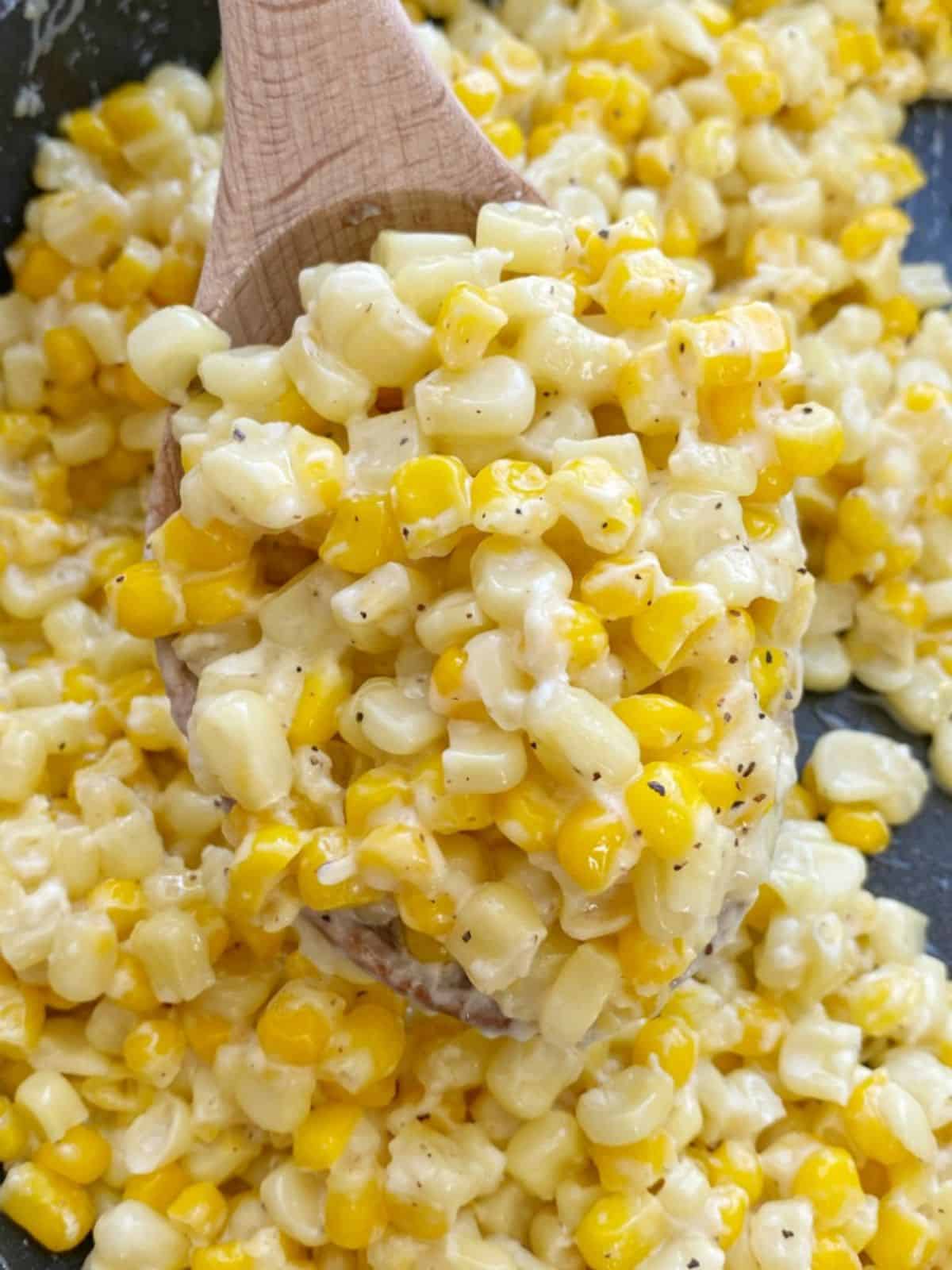 Healthy Honey Butter Skillet Corn on a wooden spatula.