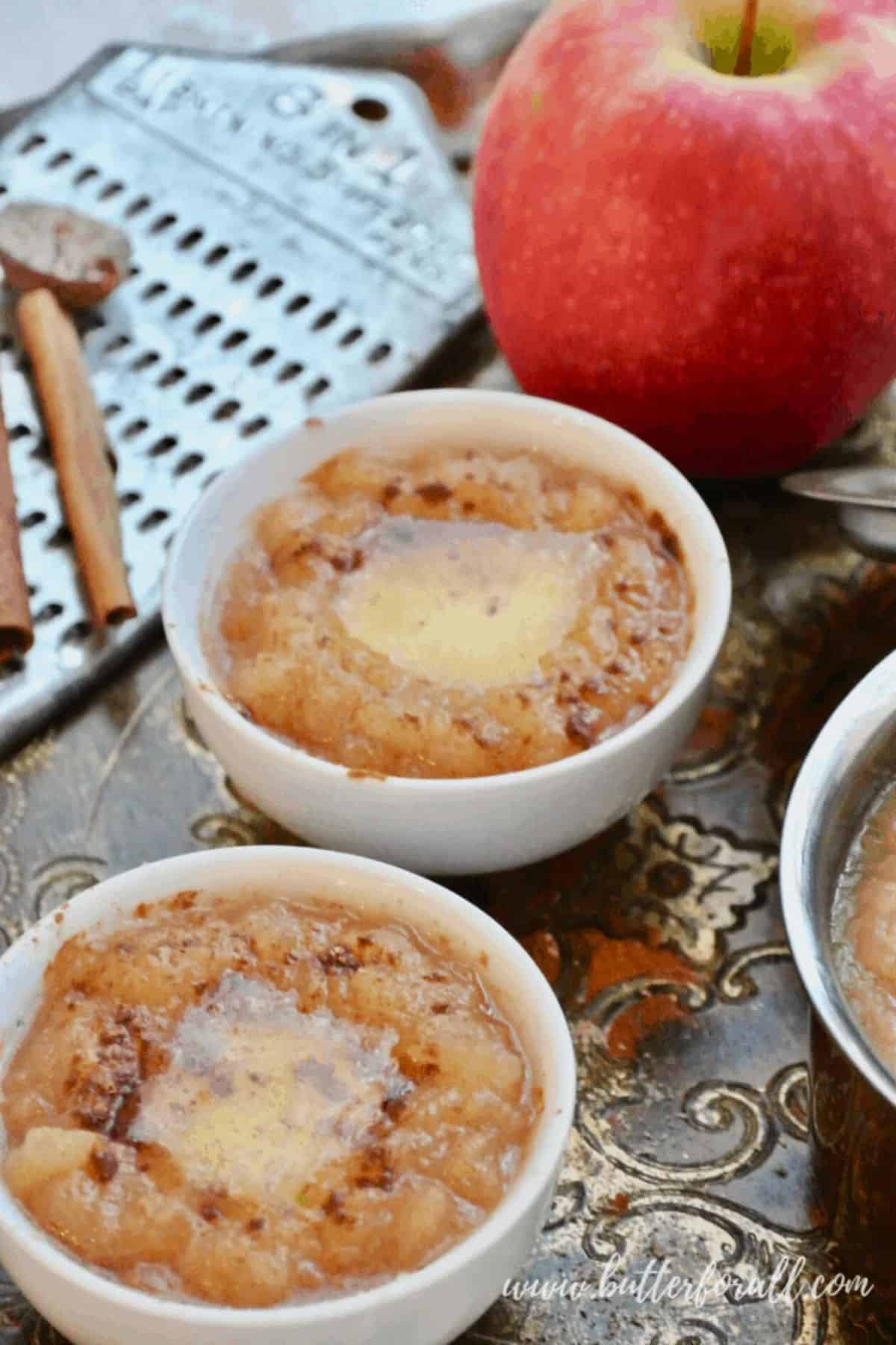 Hot Buttered Apple Sauce With Cinnamon and Nutmeg in two white bowls.