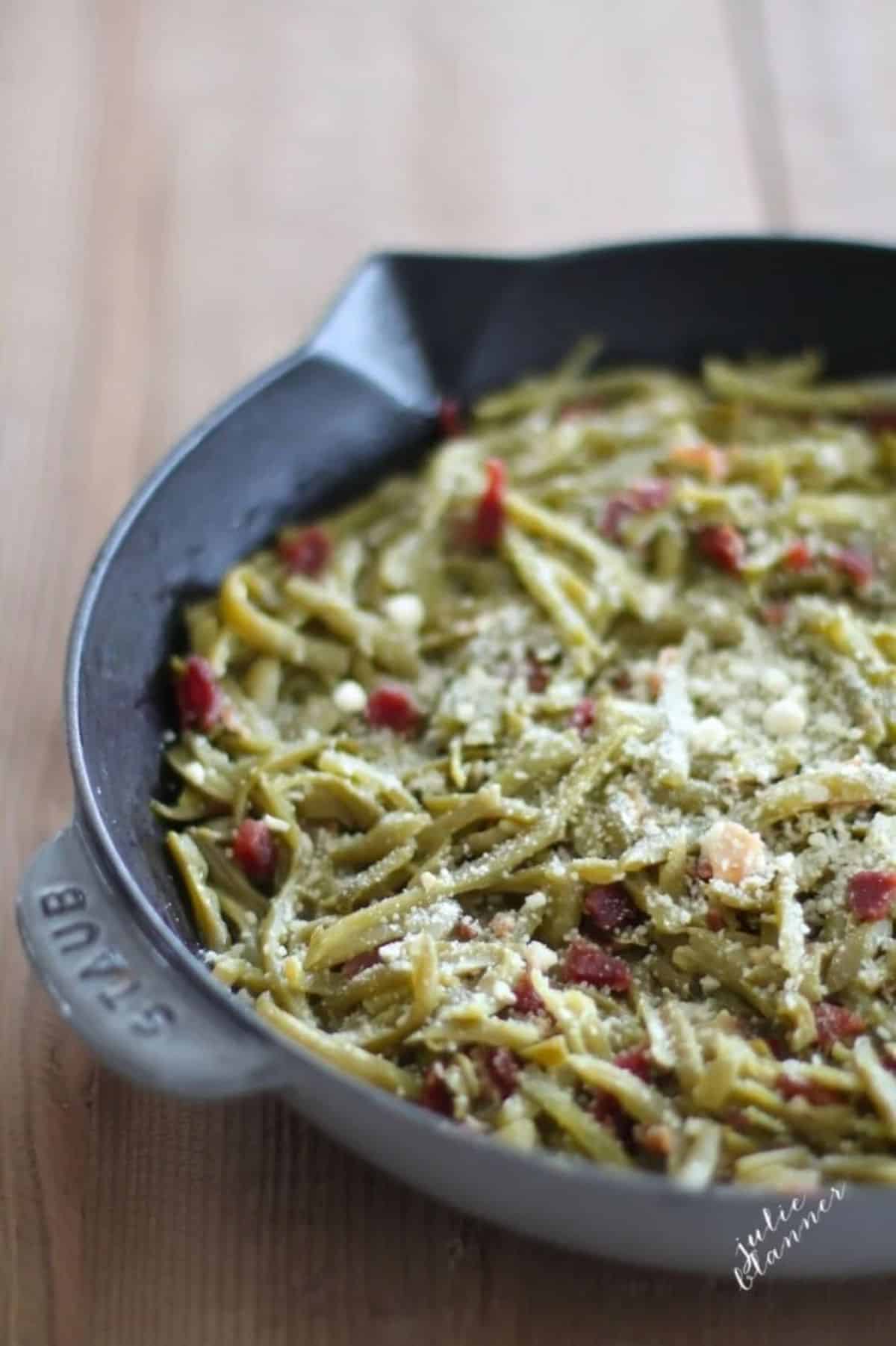 Crispy Firehouse Green Beans With Bacon in a black skillet.