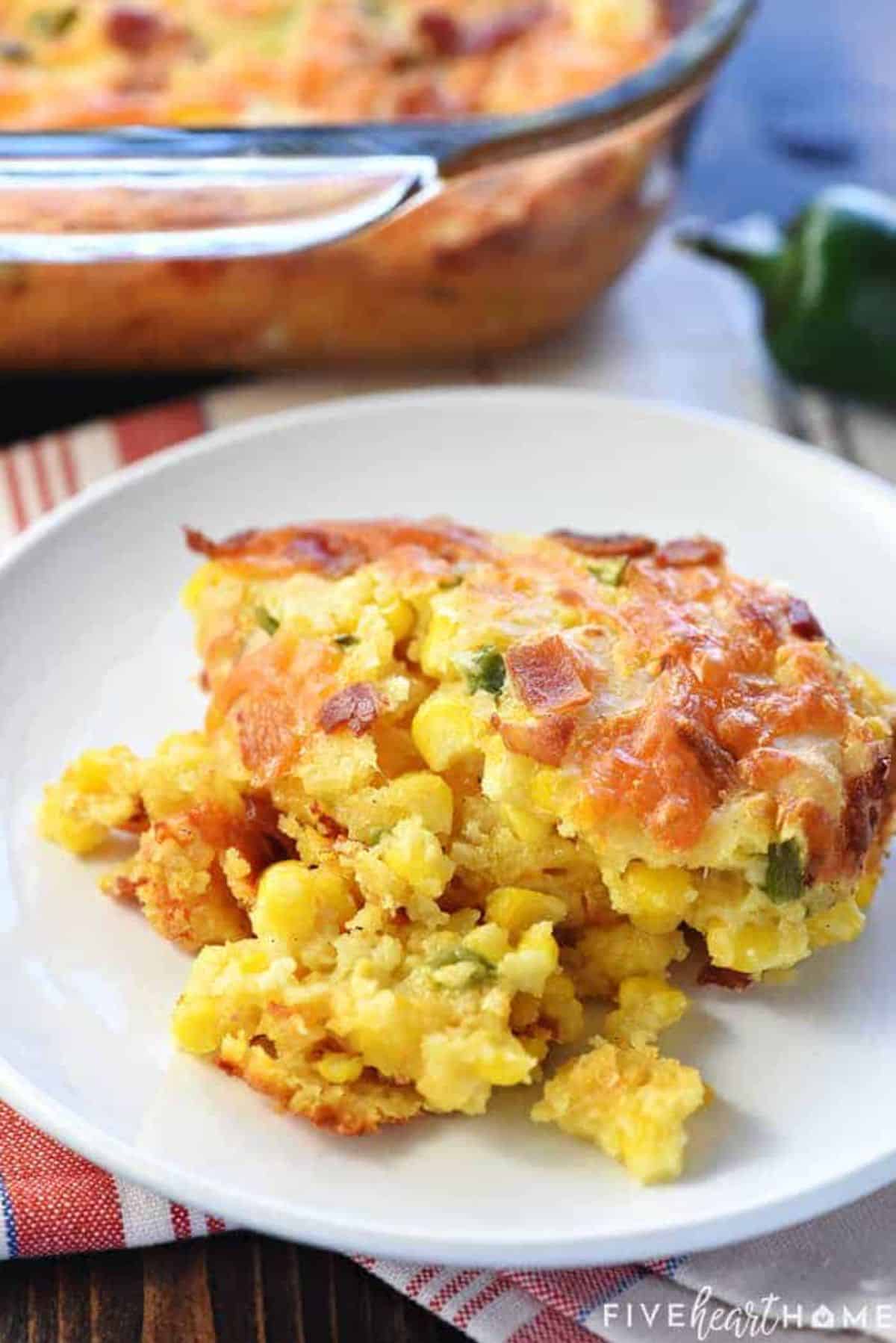 A piece of Ultimate Cornbread Casserole on a white plate.