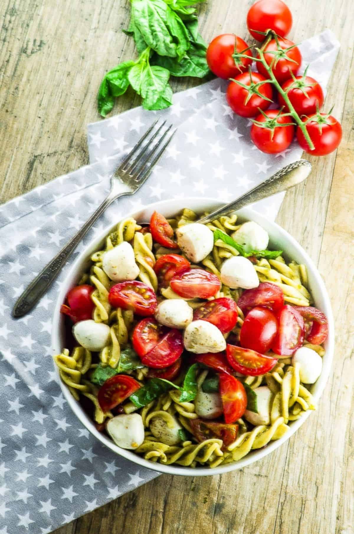 Healthy High Protein Caprese Pasta Salad on a white bowl.