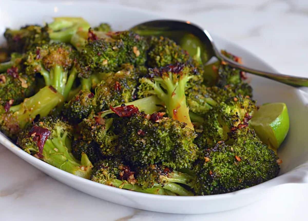 Healthy Roasted Broccoli With Chipotle Honey Butter in a bowl with a spoon.