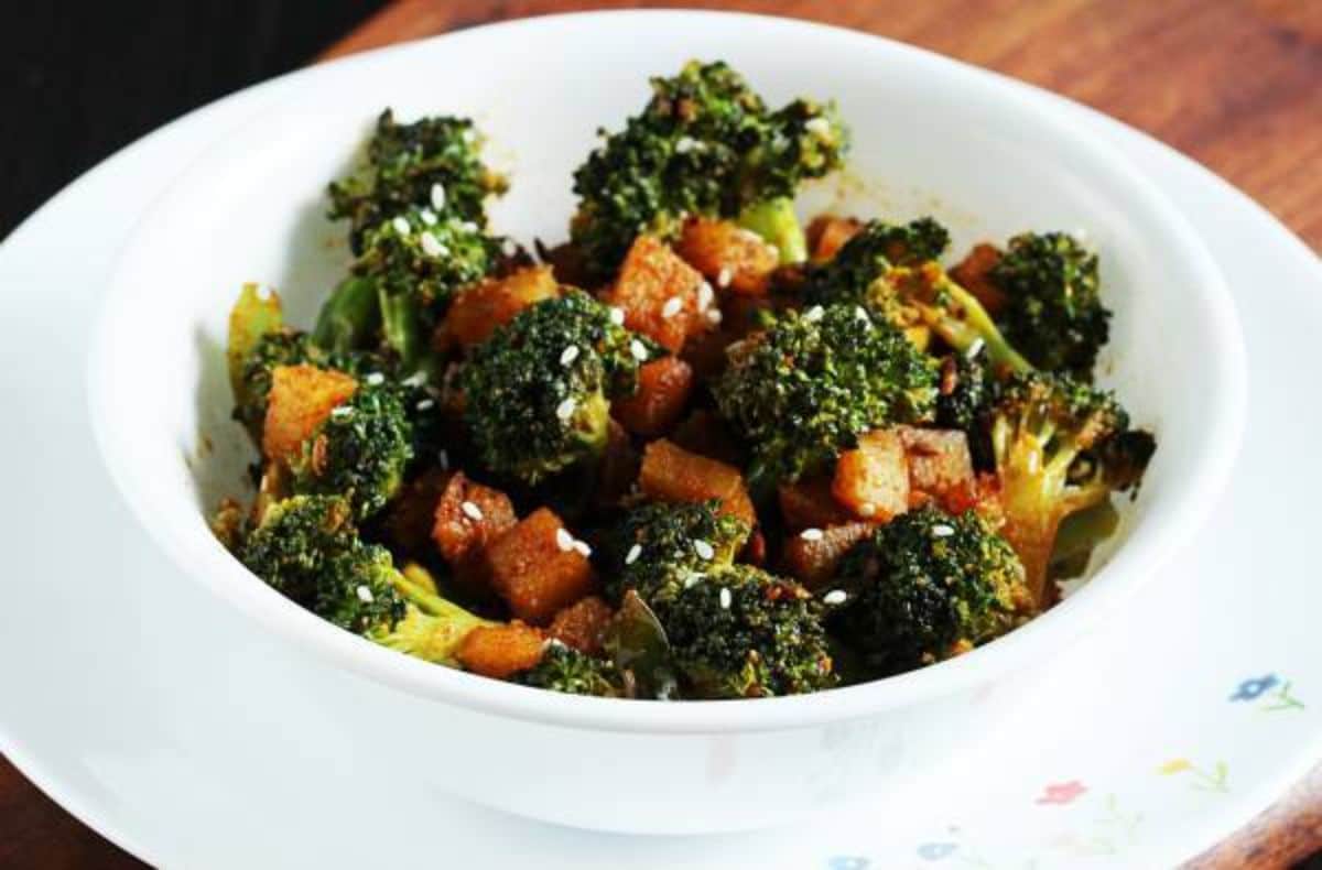 Tasty Indian Broccoli Potato Stir Fry in a white bowl.