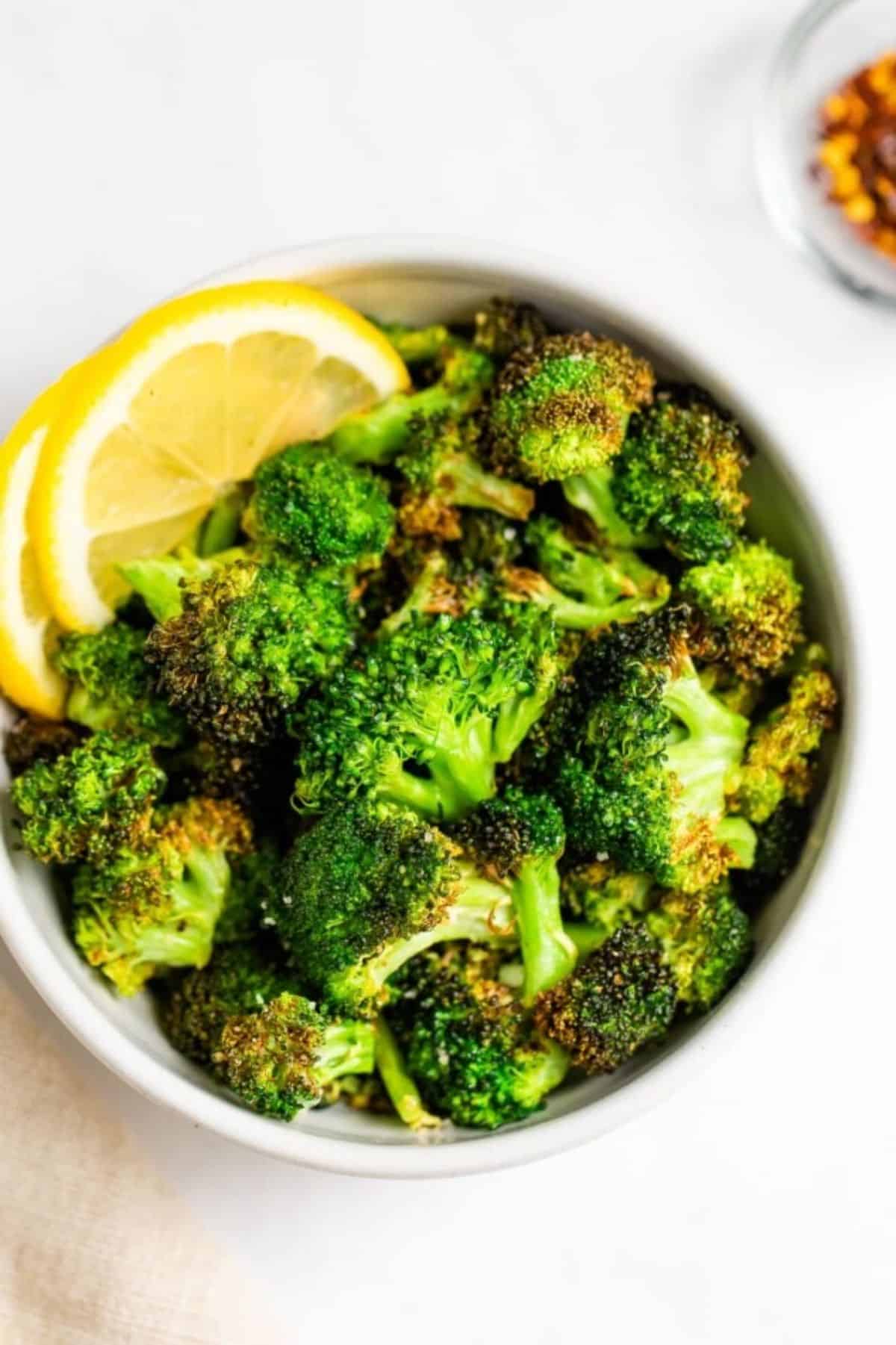 Delicious Air Fryer Broccoli in a white bowl.